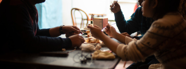 Silhouette of a group of young friends having lunch in a restaurant in a festive day. Indian lifestyle.