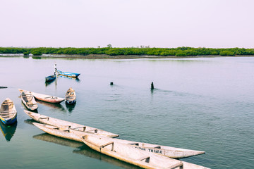 Obraz premium Fishers and small long boats. Fadiauth Island. Senegal. West Africa.