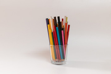 Glass pot full of colored pencils for the children to draw and make paintings