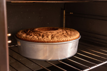Freshly baked homemade sponge cake coming out of the oven, looks delicious