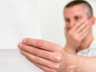 Homme lisant une mauvaise nouvelle sur une lettre