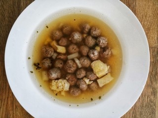 traditional northern German soup with beef, noodles and vegetable, wedding soup on brown wooden background