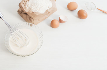 dough in glass plate and products for its preparation on  white background
