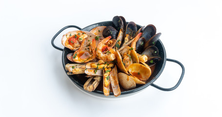Sauteed shellfish and seafood in a black pan on a white background 