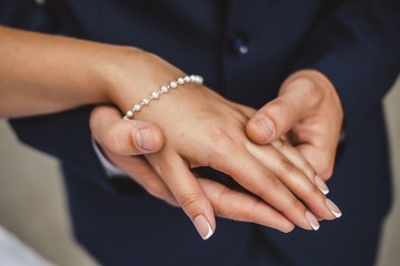 bride and groom holding hands