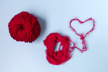 Blue background. Knitting courses. Online education. Flat lay. Top view. Place for text and design. Copy space. Knitting with love. Quarantine life. The heart of the thread