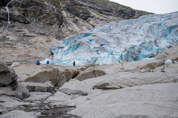 People hiking to blue glacier in the mountains