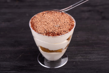 Dessert tiramisu with grated chocolate and cookies