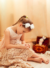 little girl is engaged in sewing at home, needlework