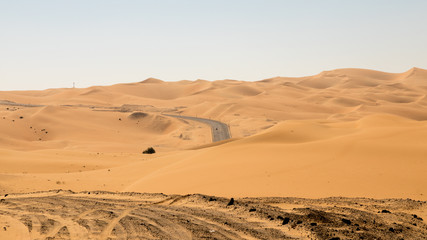 Fototapeta na wymiar Road in the Empty Quarter in United Arab Emirates, Rub' al Khali desert. 