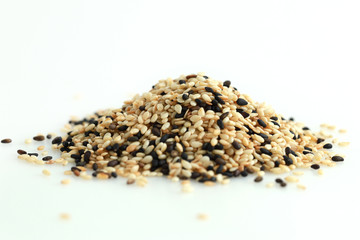Pile of white and black sesame isolated on white background.