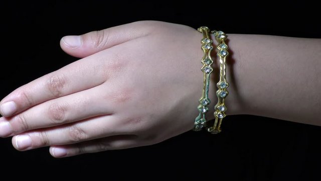 A women wearing jewellery diamond studded gold bangles wrist bracelets