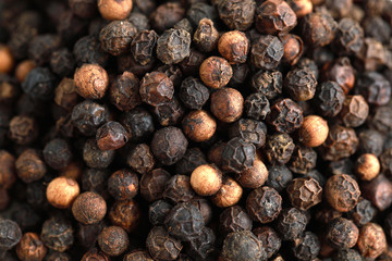 Top view pile of black peppercorns isolated on white