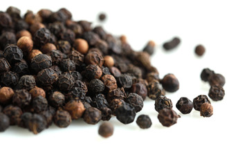 Pile of black peppercorns isolated on white