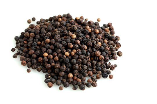 Pile Of Black Peppercorns Isolated On White