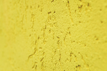 yellow cement wall, building facade as a color relief texture close-up, copy space
