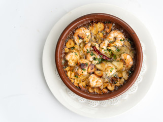 Shrimp Pil Pil with olive oil and garlic cooked in a clay pot dish
