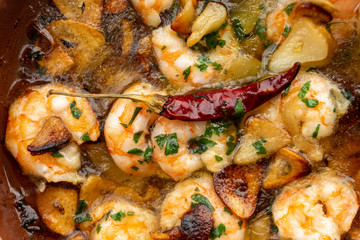 Shrimp Pil Pil with olive oil and garlic cooked in a clay pot dish