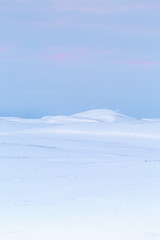 icelandic sunset across the mountains and the snow 