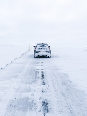 car on icelandic road with snow and ice 