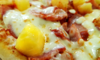 A piece of Hawaiian pizza close-up