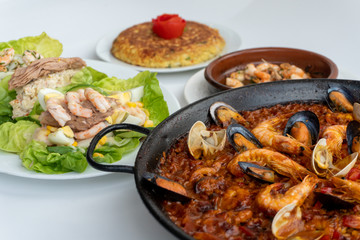 Spanish food together in one shot, paella, Tortilla espanola, Gambas Pil Pil, Ensalada de Pescado