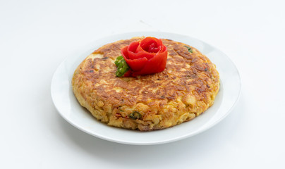 Tortilla espanola, Spanish omelette with potatoes with a tomato flower on top