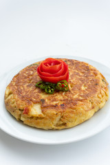Tortilla espanola, Spanish omelette with potatoes with a tomato flower on top