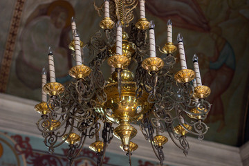 candle chandelier on the ceiling of the orthodox church