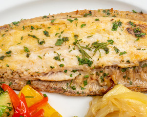 Sole meunière fish with grilled vegetables and caramelized onions on a white plate with white background. LENGUADO MENIER