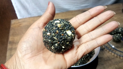 Black sesame seeds balls - sweet made with sesame and palm sugar. Tilgul Laddu or Til Gul balls for...