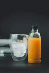 Orange juice in plastic bottle with ice cold in glass