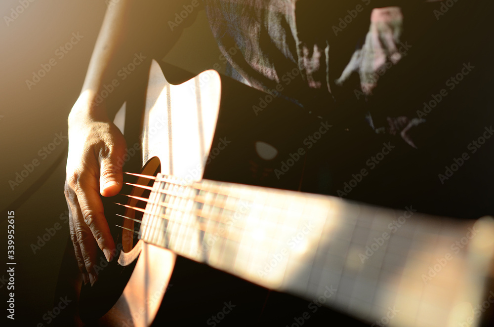 Wall mural Man playing on acoustic guitar, a pleasant, relaxing day, music and sound concept, Closeup