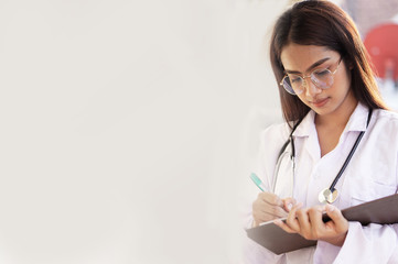 Young Asian woman the doctor doing a record in book concept.