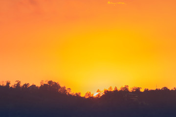 sunset orange and yellow cumulus clouds in a summer day
