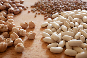 beans, chickpeas and lentils rest on a wooden table  with copy space for your text