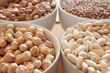 beans, chickpeas and lentils in different  bowls, with copy space for your text