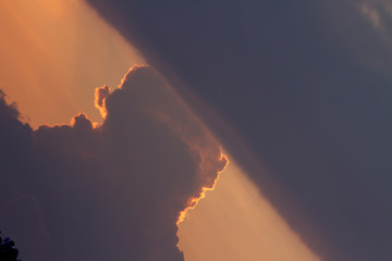 sunset orange and yellow cumulus clouds in a summer day