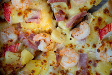 Delicious pizza with ham, shrimp and crab stick