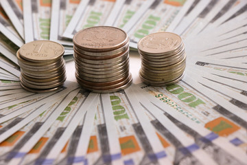 Russian coins on the background of a dollar bill. Russian money. Dollar. Ruble. Economic relations.