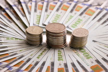 Russian coins on the background of a dollar bill. Russian money. Dollar. Ruble. Economic relations.