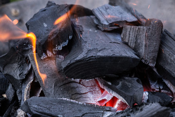 Fire burning in a fireplace. Charcoal and BBQ season.