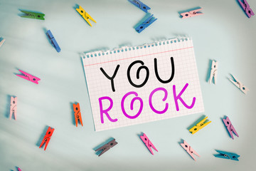 Writing note showing You Rock. Business concept for slang phrase of praise or encouragement...