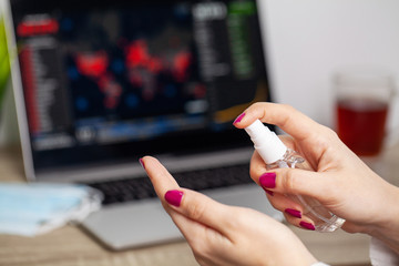 Sad woman is looking at falling stock charts during an epidemic covid-19