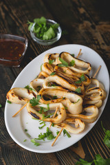 Grilled squid rings on a skewer