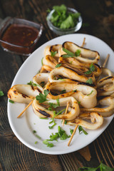 Grilled squid rings on a skewer