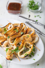 Grilled squid rings on a skewer