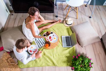 Happy mom and botare imitating summer picnic time