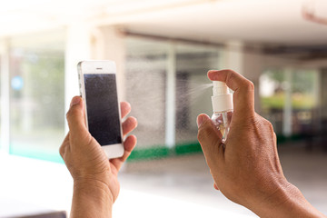 Men use alcohol spray to get rid of bacteria and viruses on mobile phones, Inhibition and...
