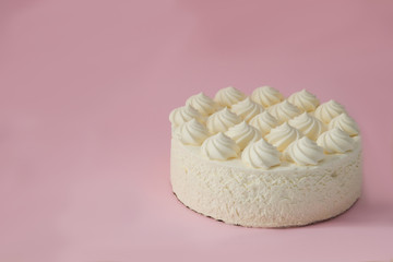 White cream cake on a pink background. Multi-colored sprinkles for cakes. Space for text